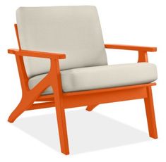 an orange and gray chair with armrests sitting on a white background in front of a white backdrop