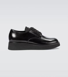 Italian-crafted in a smooth brushed leather, these black Derby shoes from Prada take on a modern interpretation with a rubber platform sole..Lining: leather.Sole: leather insole, rubber sole.Upper: calf leather.Toe shape: square toe.Closure: lace-up.Designer color name: Nero.Made in Italy.True to size.Half sizes please take the next size up.UK sizes.4,0cm-1.5' heel (size EU 42)