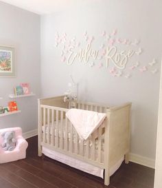 a baby's room with pink and white decor