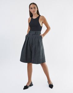 High-waisted knee-length shorts IPANTS.A wide waistband along with front pleats highlight the waist and make it visually thinner. Bermuda shorts are made from 100% striped wool in dark grey color and have an extra lining to be more pleasant to the body. Shorts have comfortable side pockets and faux pockets on the back. Belt loops, zip, and hook-and-eye closures on the middle.Composition: 100% woolLining: 100% viscoseCare: We recommend a professional dry clean. Do not wash. Do not bleach. Do not Gray Workwear Shorts, Elegant Gray Short Length Bottoms, Gray Pleated Short Skirt, Gray Knee-length Workwear Bottoms, Gray Knee-length Bottoms For Workwear, Chic Gray Knee-length Bottoms, Body Shorts, Knee Length Shorts, Dark Grey Color