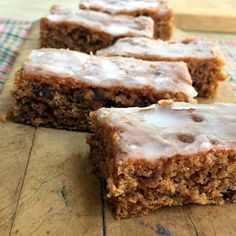 several pieces of cake sitting on top of a wooden table