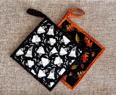 a black and white square with halloween decorations on it next to an orange handled bag