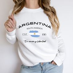 Argentina sweatshirt, hoodie, World cup Argentina sweatshirt, Argentina, Argentina gift, Gift, Gift shirt,Argentina Soccer Sweatshirt  Ideal for any situation, a unisex heavy blend crewneck sweatshirt is pure comfort. These garments are made from polyester and cotton. This combination helps designs come out looking fresh and beautiful. The collar is ribbed knit, so it retains its shape even after washing. There are no itchy side seams on these sweaters.  .: 50% cotton, 50% polyester .: Medium-he White Casual Hoodie With Name Print, Casual White Hoodie With Name Print, Casual Crew Neck Hoodie With Name Print, White Fleece Sweatshirt For Fan Merchandise, World Cup Argentina, Soccer Sweatshirt, Argentina Soccer, Favorite Shirts, Sweatshirt Hoodie