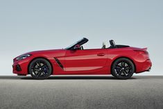 the new bmw z4 roadster convertible is shown in red with its top down