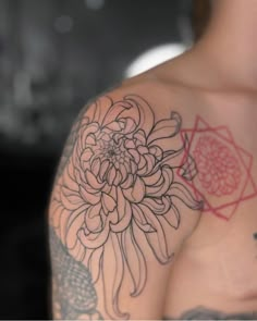 a man with a flower tattoo on his shoulder