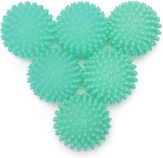 four green plastic balls on a white background