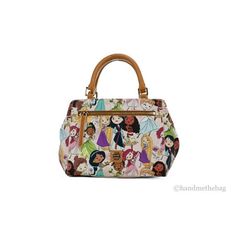 Style: Dooney & Bourke Disney Princesses Satchel Crossbody Handbag Material: Coated Cotton and Smooth Leather Features: Canvas Lining, Inner Zip and Slip Pockets, Outer Zip Pockets, Key Clip, Protective Bottom Studs, Adjustable/Detachable Crossbody Strap Allover Print: Tiana, Moana, Ariel, Cinderella, Rapunzel, Mulan, Jasmine, and Belle Measures: 9.5" W x 7.5" H x 4.75" D MSRP: $268 Size: 7.25" H x 9.5" W x 4.75" D Strap Drop Length 25.5" Handle Drop Length: 4.5".  Color: Pink.  Gender: female. Dooney And Bourke Disney, Disney Dooney, Stylish Purse, Key Clip, Dooney & Bourke Bags, Wallet Fashion, Branded Handbags, Disney Princesses, Handbag Purse