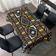 a dining room table covered with a black and yellow blanket