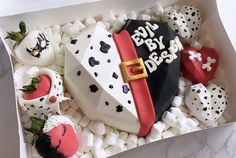 a box filled with lots of white and black cake covered in frosted strawberries