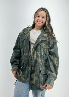 Keep it cool in camo in this jacket from our We The Free collection, featured in a cotton fabrication and slouchy silhouette with utility-inspired pockets and a collared neckline. Fit: Slouchy, relaxed fitFeatures: Cotton fabrication with camo print all over, collared-neckline, long-sleeves with cuffs, snap-button placket with front-zip closure, utility-inspired pocketsWhy We ❤ It: Made for layering, this jacket adds the perfect touch of utility to any outfit. Not quite your style? Shop jackets Oversized Military Outerwear With Pockets, Oversized Utility Jacket With Patch Pockets For Outdoor, Oversized Utility Jacket With Flap Pockets For Outdoor, Oversized Utility Jacket With Cargo Pockets, Oversized Utility Jacket With Cargo Pockets For Fall, Oversized Military Utility Jacket With Pockets, Long Sleeve Camouflage Utility Jacket, Oversized Military Utility Jacket For Spring, Oversized Military Cotton Utility Jacket