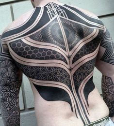 the back of a man with tattoos on his body