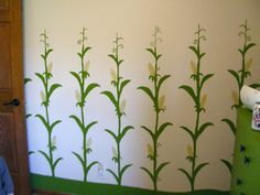 a child's room with a green and white wallpaper design on the wall