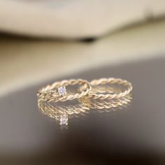 A beautifully hand-twisted band of 14k yellow gold, this ring is designed for effortless style. Its delicate twist adds a subtle texture, making it a versatile piece you can wear on any finger or stack alongside other rings. Whether worn alone for a minimalist look or layered for added dimension, this ring is a timeless addition to any collection, perfect for everyday wear or special occasions. Details: Metal: Solid 14k Yellow Gold Finish: High-polish Band Width: 2mm Shipping & Customization: Pl Twisted Gold Ring, Free Spirit Style, Rope Twist, Gem Diamonds, Bypass Ring, Twisted Band, Womens Engagement Rings, Gold Band, Round Cut Diamond