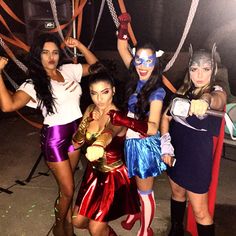 four women dressed up in costumes posing for the camera