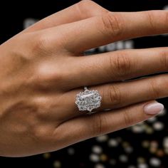 a woman's hand with a diamond ring on it