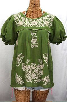 "The \"La Mariposa Corta\" Mexican Blouse by Siren: * Ornate hand embroidery and traditional puff sleeves, available here in FERN GREEN with CREAM embroidery. * Light, gauzy and semi-sheer 100% cotton throughout; wear it billowy and flowing in the traditional bohemian style. * Dyed, distressed and embroidered entirely by hand for an authentic, retro-vintage and hippie casual vibe. * Our ornate butterfly floral embroidery patterns are a faithful tribute to the original Mexican style hippie blouse Mexican Peasant Blouse, Cream Embroidery, Hippie Blouse, Mexican Blouse, Floral Embroidery Patterns, Fern Green, Mexican Style, Peasant Top, White Embroidery