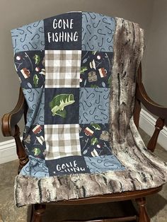 a chair with a blanket on it that says gone fishing