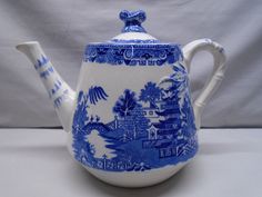 a blue and white tea pot with a handle