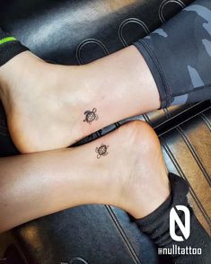 two people with matching tattoos on their feet, one has a turtle and the other has a