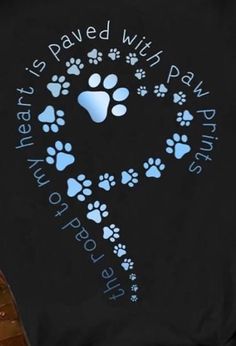 a black shirt with blue paw prints on it