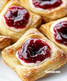 small pastries with jelly filling on a white plate