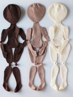 five different colored doll bodies are arranged in the shape of an adult and child's body