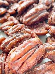 several pieces of pecans sitting on top of a white plate with brown flecks