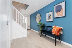 a hallway with blue walls and pictures on the wall