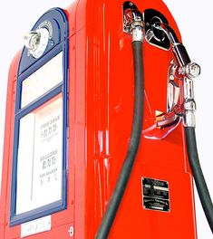 a red gas pump with hoses connected to it's tank and nozzle