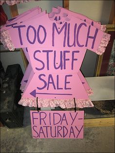 a pink sign that says too much stuff stuff sale friday - saturday on the floor