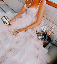 a woman in a white dress sitting on a couch