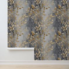 a curtain with gold leaves on it in front of a white wall and wooden floor