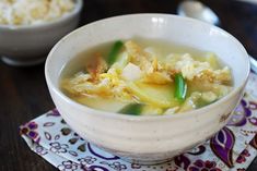 a white bowl filled with soup on top of a table