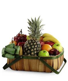 a wooden basket filled with lots of different types of fruit