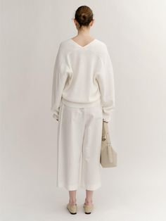 The oversized knit pullover. Featuring the deep V-neckline, drop shoulder design, and oversized silhouette. The soft color, basic details, and relaxed fit are accentuated. - Deep V-neckline and drop shoulder design- Oversized silhouette and cropped length- Ribbed trim at sleeves and hem- Both basic and feminine mood Oversized V-neck Sweater For Work, Oversized Chic V-neck Sweater, Oversized V-neck Sweater For Loungewear, Oversized V-neck Chic Sweater, Oversized V-neck Sweater For Spring Workwear, Relaxed Fit V-neck Knit Top For Work, V-neck Sweater For Loungewear, Oversized V-neck Fine Knit Sweater, Oversized Fine Knit V-neck Sweater