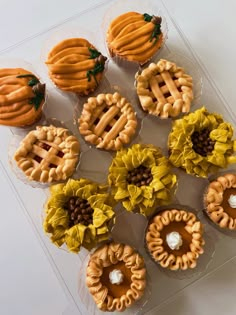 several cupcakes in plastic cases with flowers on the top and leaves on the bottom