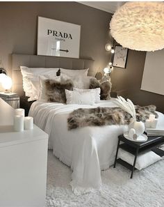 a bedroom with white bedding and fluffy pillows