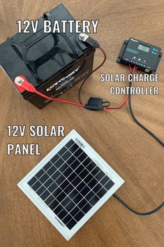 the solar panel is connected to a battery and charger on top of a wooden table