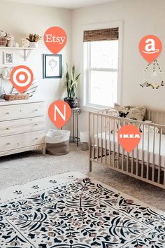 a baby's nursery with orange and white decals on the wall, including letters