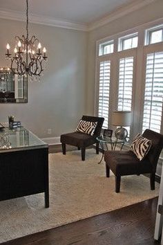 a living room filled with furniture and a chandelier