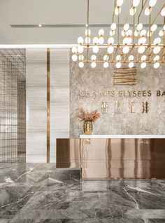 an elegant lobby with chandelier and marble flooring is seen in this rendering