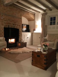 a living room filled with furniture and a fire place