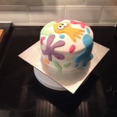 a decorated cake sitting on top of a stove