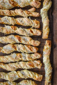 bread sticks are lined up on a wire rack and ready to be cooked in the oven