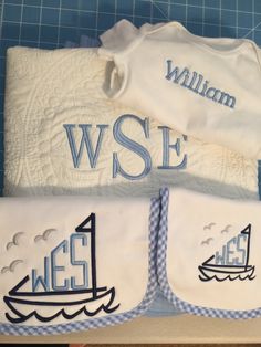 two baby onesuits with sailboats on them and the name william wse