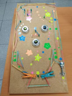 a wooden table topped with lots of crafting supplies on top of it's surface