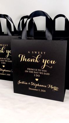 three black bags with gold foil lettering and thank you written on the front, one is for