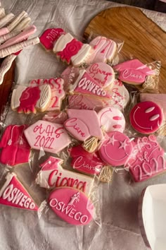 pink and white decorated cookies sitting on top of a table