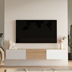 a flat screen tv mounted to the side of a white wall in a living room