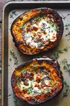 two stuffed eggplant halves with cheese and herbs